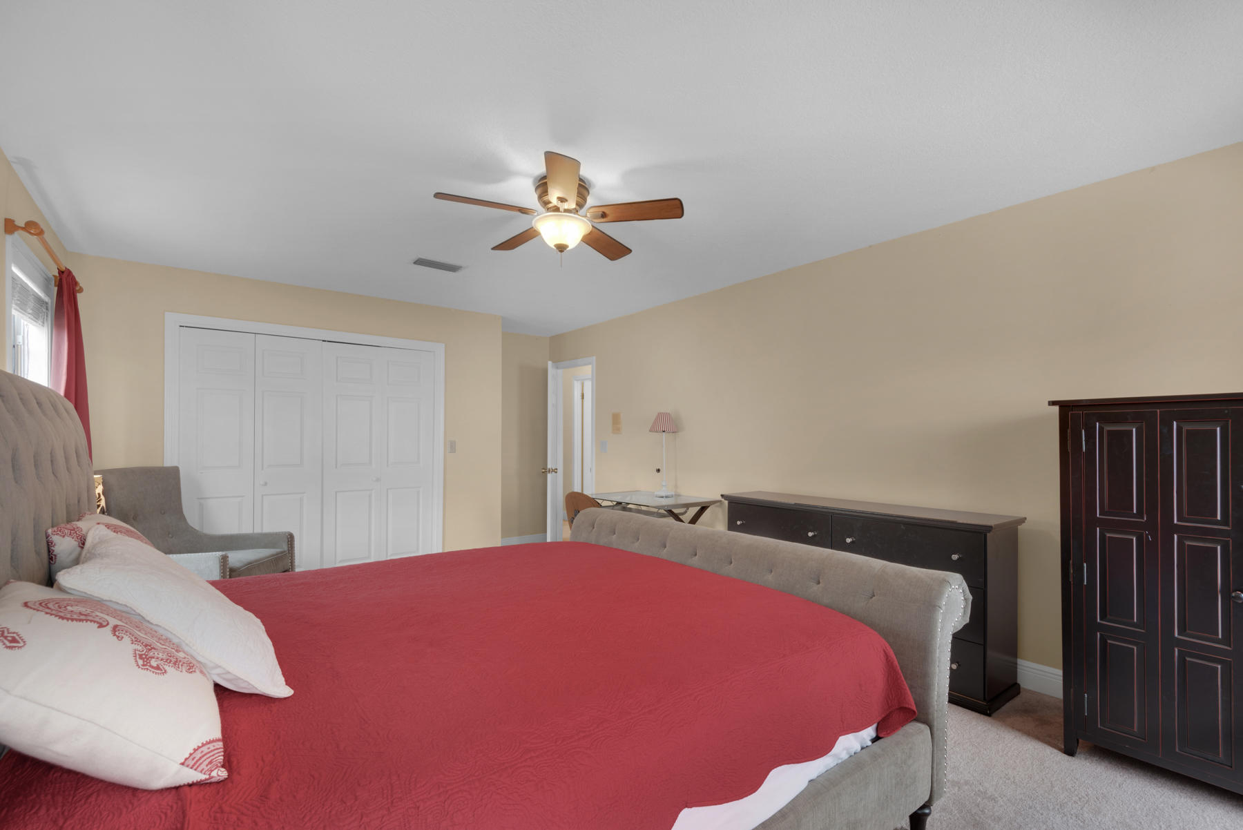 44 Dolphin Place Freeport, FL 32439 - Photo 30 of 76 a bedroom with a large bed and a chandelier