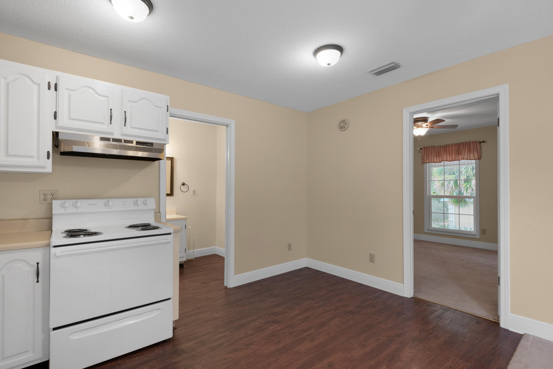 44 Dolphin Place Freeport, FL 32439 - Photo 40 of 76 a kitchen with cabinets stainless steel appliances and wooden floor