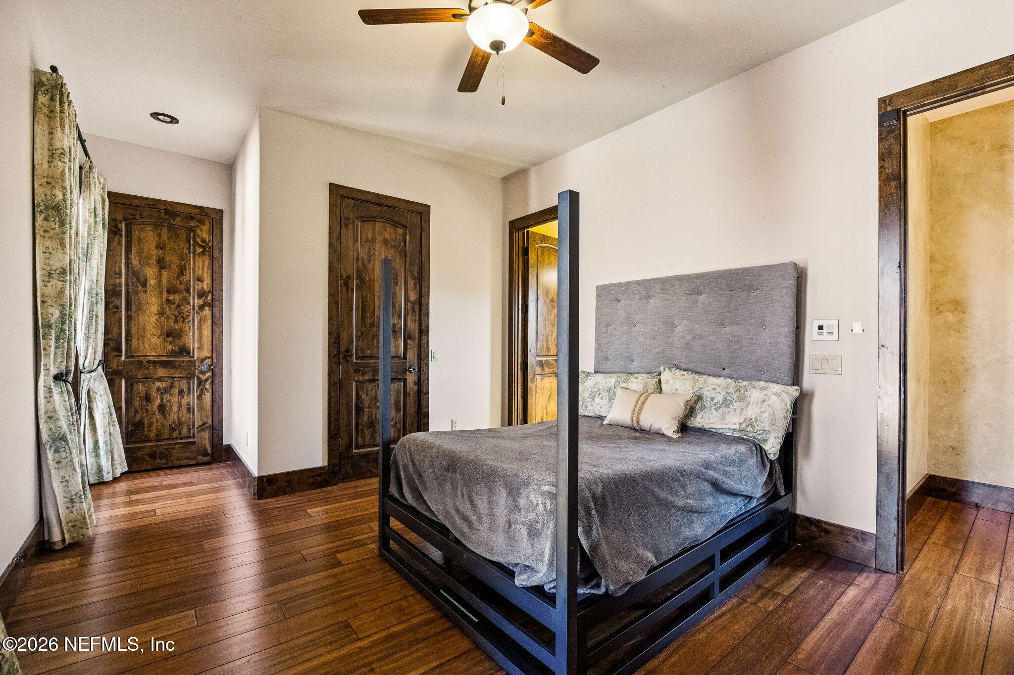 3533 Crest Street St. Augustine, FL 32092 - Photo 53 of 79 a large bedroom with a bed and wooden floor