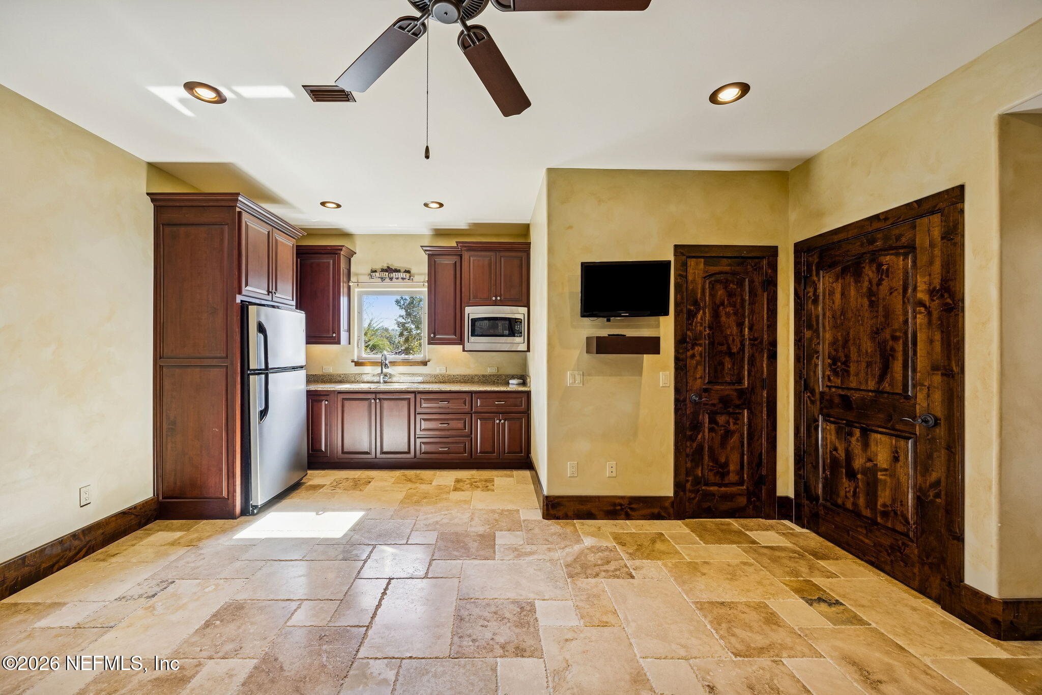 3533 Crest Street St. Augustine, FL 32092 - Photo 55 of 79 a kitchen with stainless steel appliances kitchen island granite countertop a refrigerator and a sink