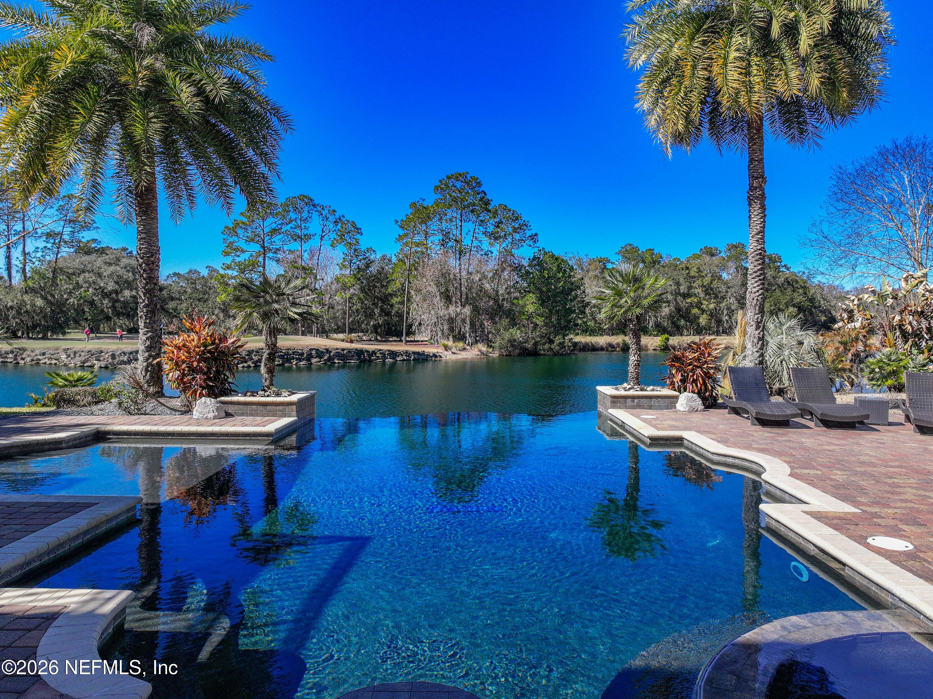 3533 Crest Street St. Augustine, FL 32092 - Photo 6 of 79 a view of a lake with a table and chairs