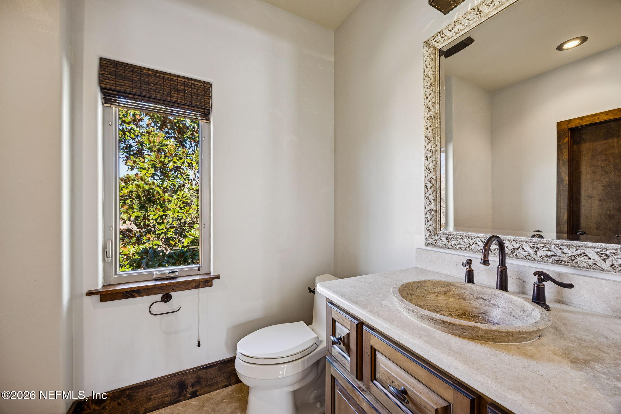3533 Crest Street St. Augustine, FL 32092 - Photo 63 of 79 a bathroom with a granite countertop sink toilet and mirror