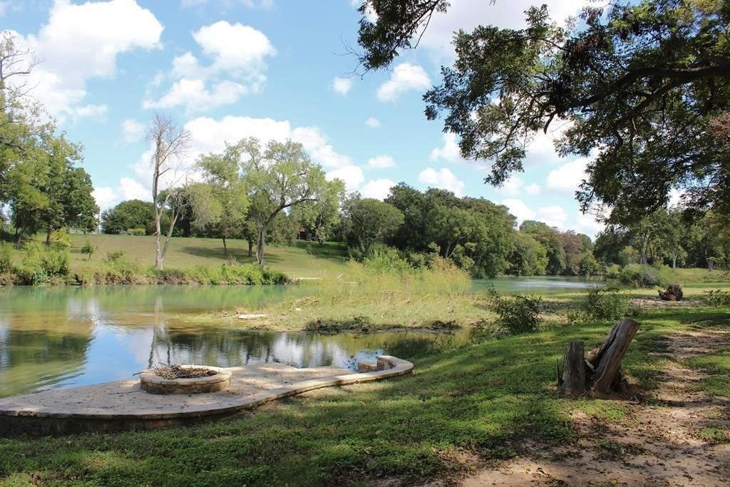510 River Ranch Circle Martindale, TX 78655 - Photo 11 of 20 a view of a lake with a yard and trees