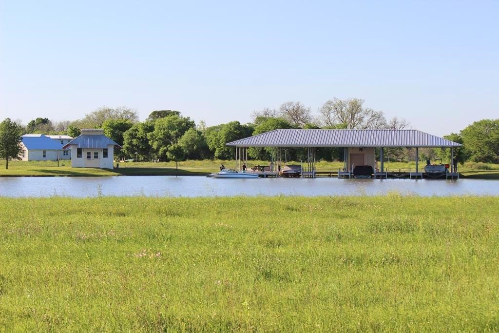 510 River Ranch Circle Martindale, TX 78655 - Photo 17 of 20 a view of a swimming pool with lawn chairs under an umbrella