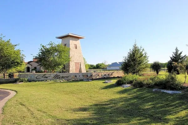 a body of water with a tree in the background