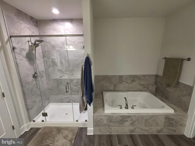 a bathroom with a tub and a shower