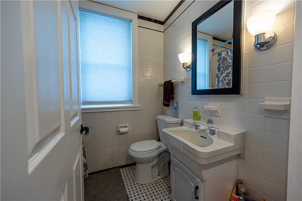 162 Conestoga Road Pittsburgh, PA 15235 - Photo 10 of 25 a bathroom with a toilet a sink and mirror