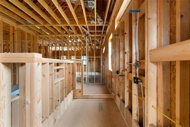 a view of an empty room with floor to ceiling windows and stairs