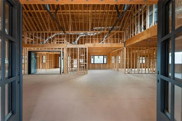 a living room with lots of furniture and kitchen view