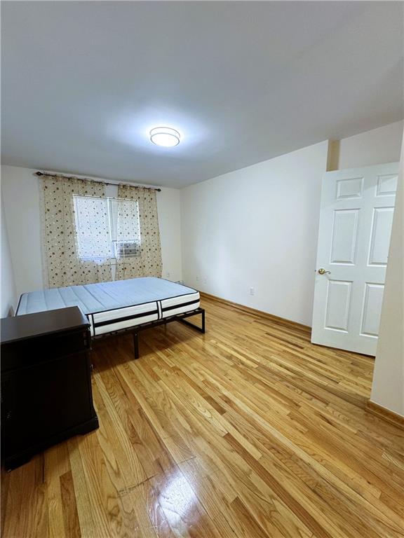 2650 East 26th Street, Unit 1A Brooklyn, NY 11235 - Photo 11 of 14 a room with wooden floor and window