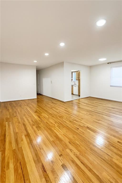 2650 East 26th Street, Unit 1A Brooklyn, NY 11235 - Photo 5 of 14 a view of empty room with wooden floor