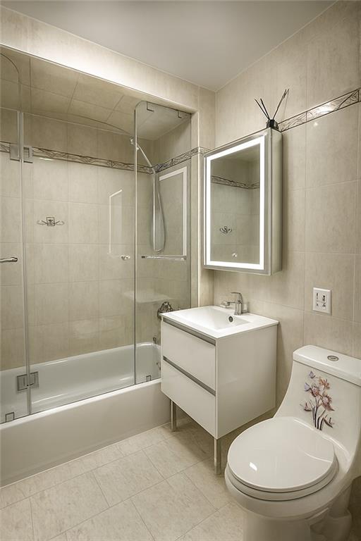 2650 East 26th Street, Unit 1A Brooklyn, NY 11235 - Photo 8 of 14 a bathroom with a sink toilet and shower