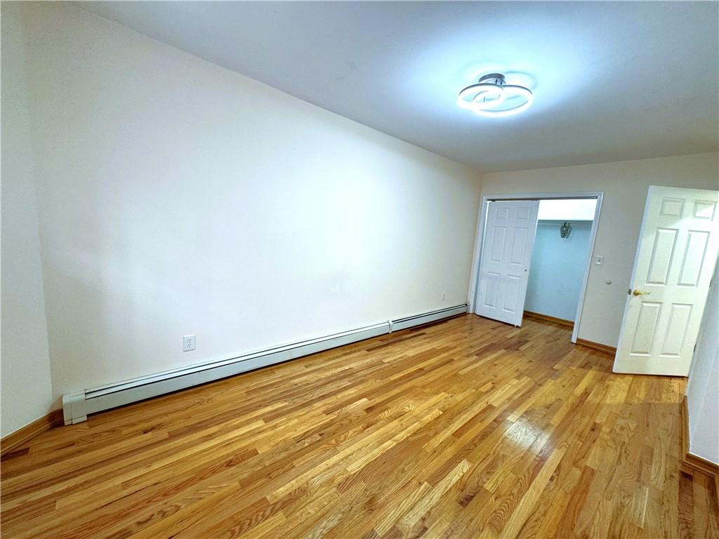 2650 East 26th Street, Unit 1A Brooklyn, NY 11235 - Photo 10 of 14 a view of empty room with wooden floor