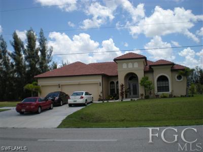 1629 Old Burnt Store Road North Cape Coral, FL 33993 - Photo 1 of 10 a couple of cars parked in front of a house