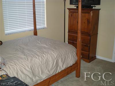 1629 Old Burnt Store Road North Cape Coral, FL 33993 - Photo 8 of 10 a bedroom with a bed and a window