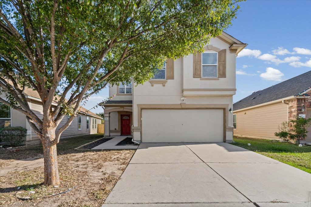 11229 Kirkland Hill Path Austin, TX 78754 - Photo 9 of 15 View of front of property featuring stucco siding, a 2-car garage, and driveway