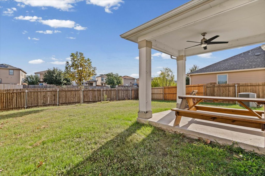 11229 Kirkland Hill Path Austin, TX 78754 - Photo 10 of 15 Fenced backyard with a ceiling fan, a covered patio