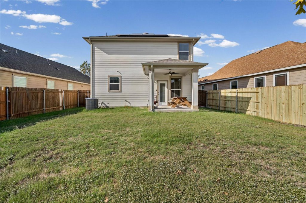 11229 Kirkland Hill Path Austin, TX 78754 - Photo 11 of 15 Back of property with ceiling fan, solar panels, a patio, and a fenced backyard