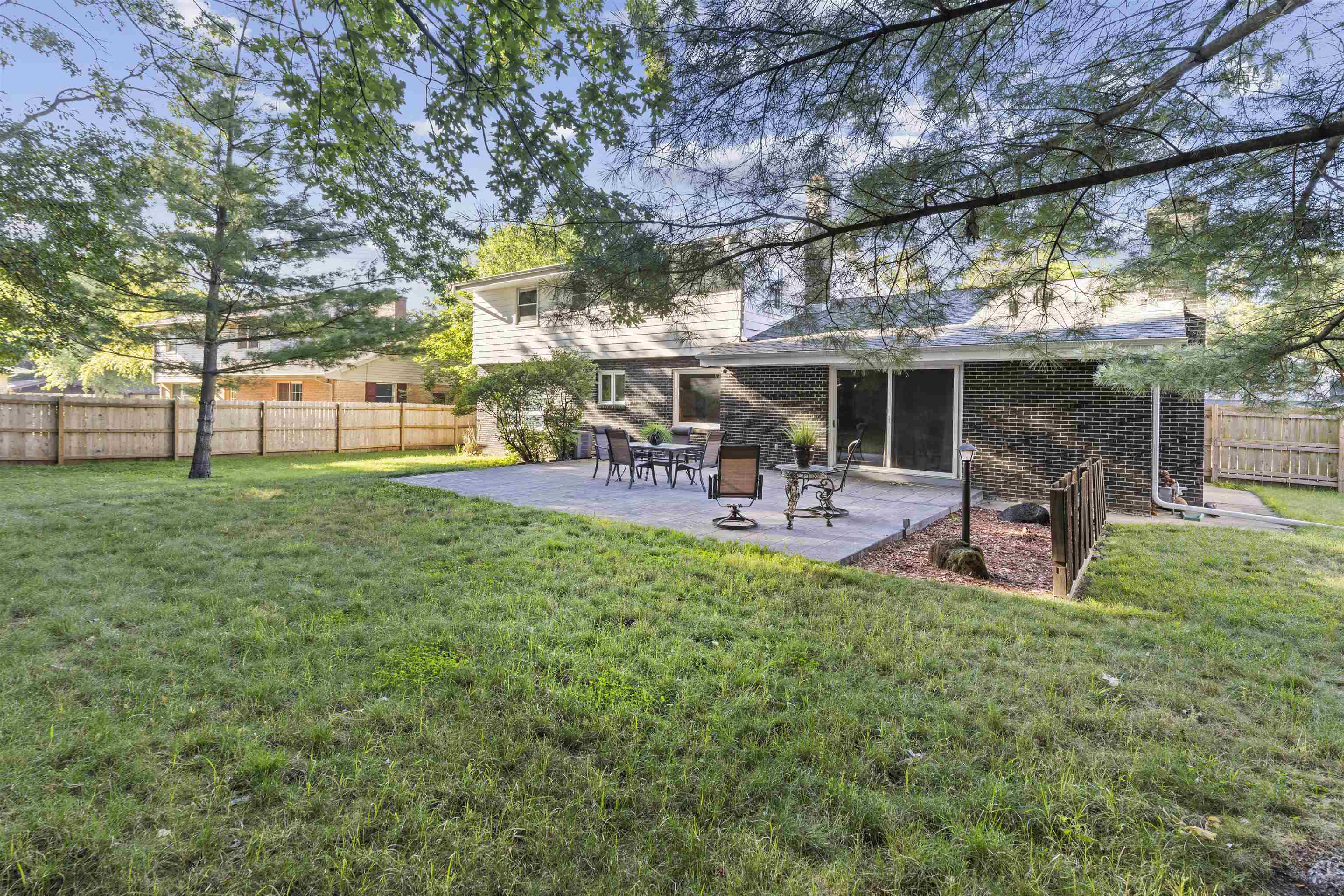 4976 Brigadoon Road Rockford, IL 61107 - Photo 30 of 32 a view of a backyard of a house with table and chairs