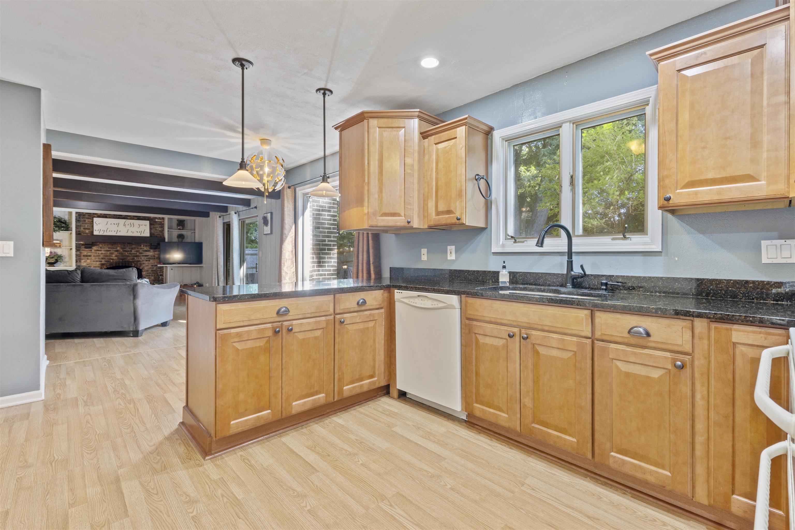 4976 Brigadoon Road Rockford, IL 61107 - Photo 9 of 32 a kitchen with stainless steel appliances granite countertop a sink a stove cabinets and wooden floor