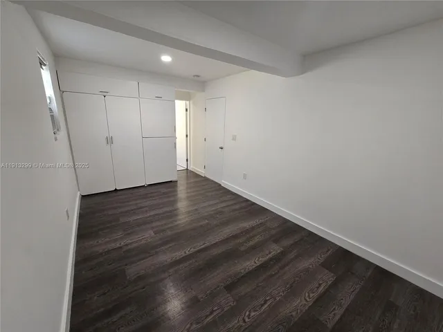a kitchen with wooden floors and appliances