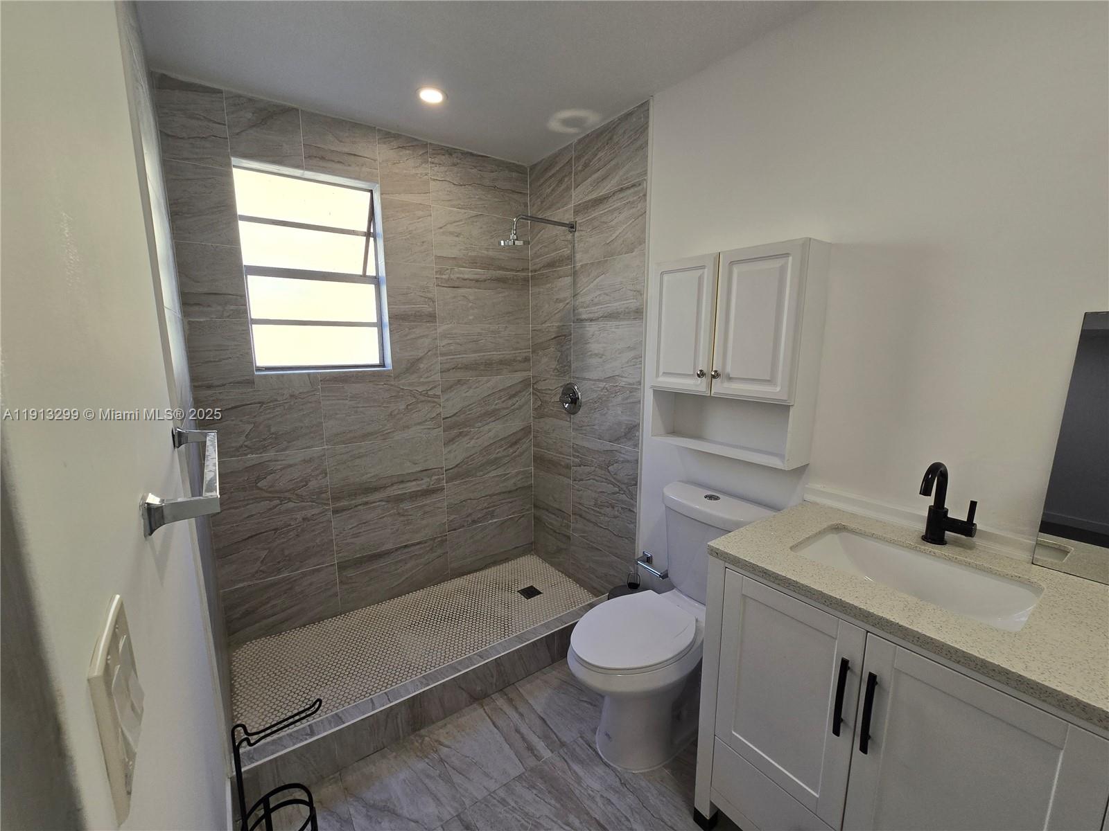 1629 Southwest 6th Street, Unit 13 Miami, FL 33135 - Photo 17 of 74 a bathroom with a sink a toilet and shower