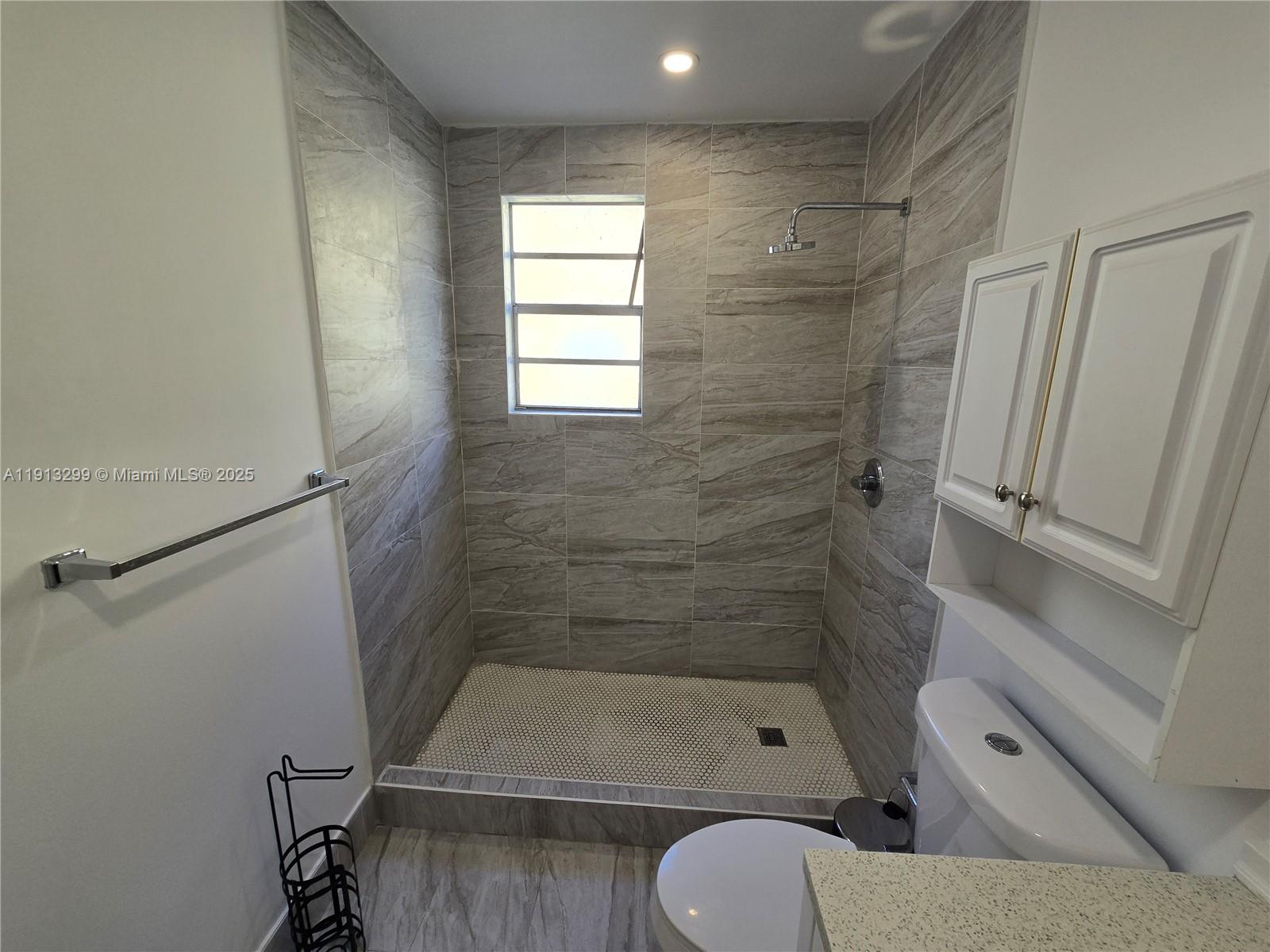 1629 Southwest 6th Street, Unit 13 Miami, FL 33135 - Photo 18 of 74 a bathroom with a shower a toilet and sink