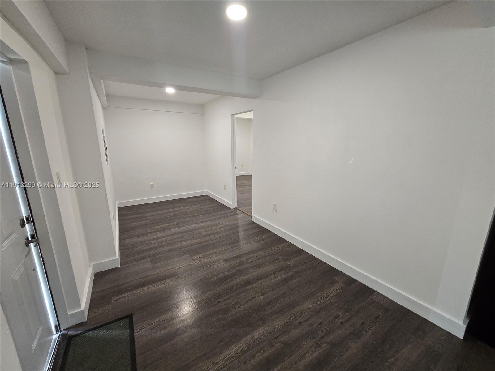 1629 Southwest 6th Street, Unit 13 Miami, FL 33135 - Photo 22 of 74 an empty room with wooden floor and entrance