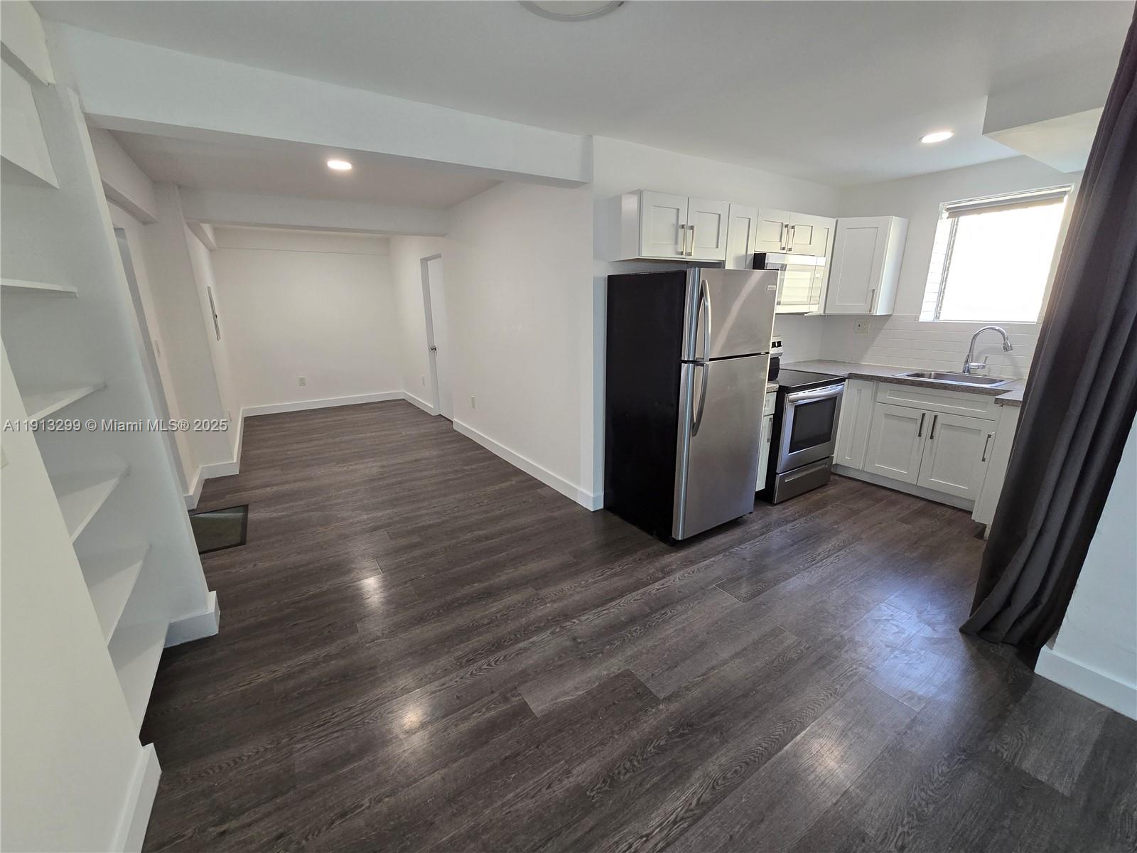 1629 Southwest 6th Street, Unit 13 Miami, FL 33135 - Photo 23 of 74 a kitchen with wooden floors and appliances