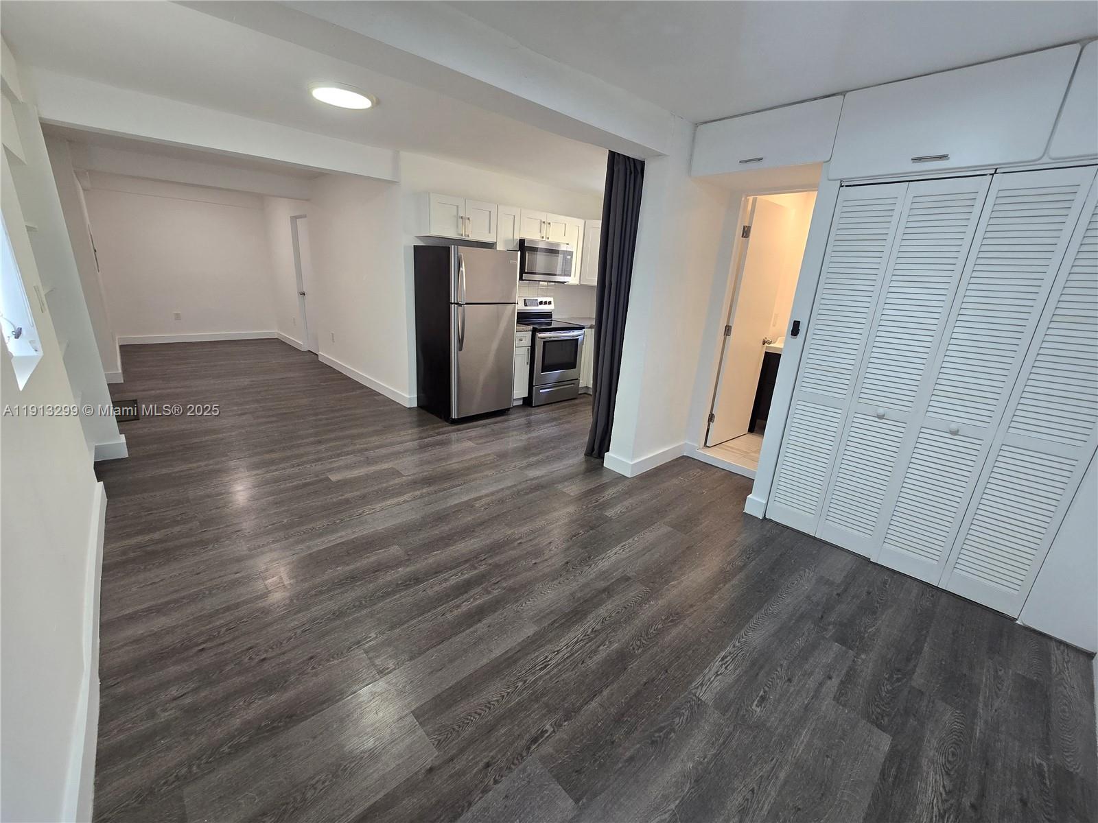 1629 Southwest 6th Street, Unit 13 Miami, FL 33135 - Photo 26 of 74 an empty room with wooden floor and windows