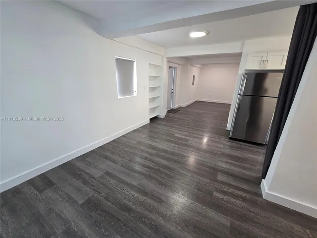 a view of wooden floor and windows in a room