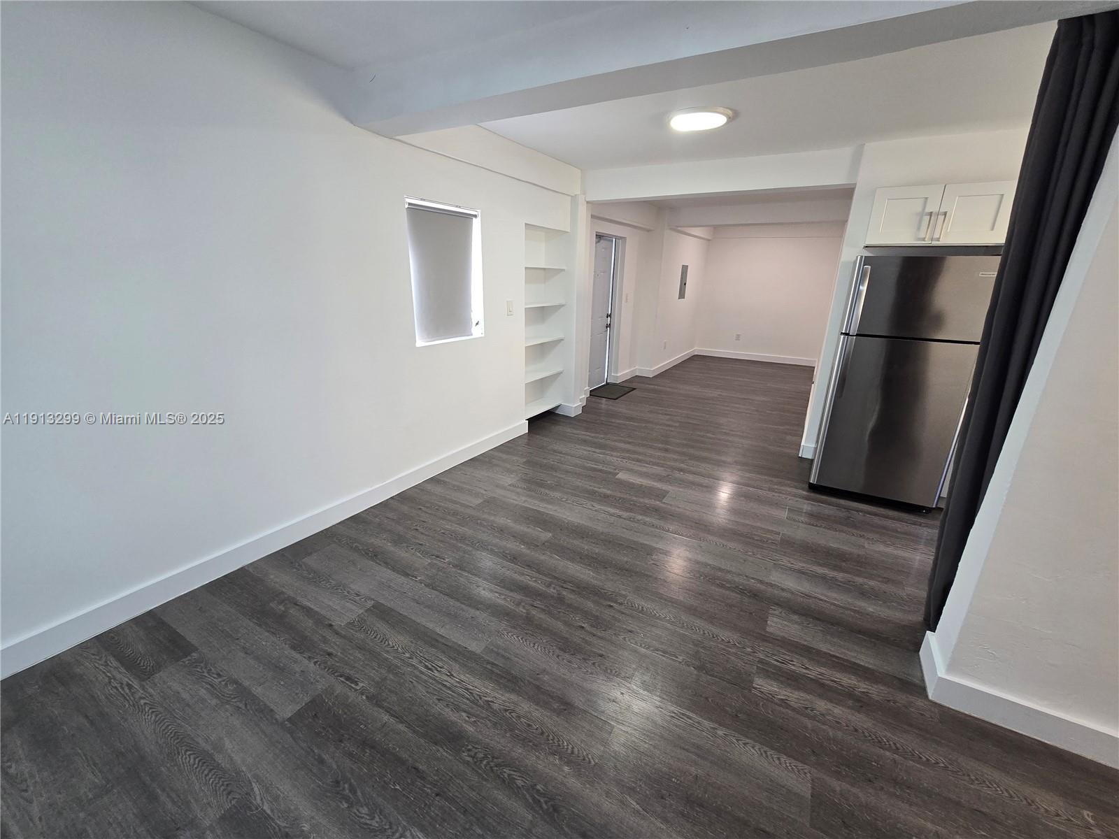 1629 Southwest 6th Street, Unit 13 Miami, FL 33135 - Photo 27 of 74 a view of empty room with wooden floor and window