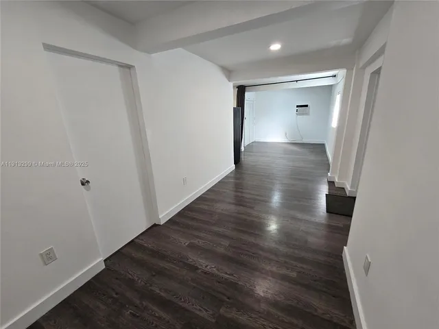 a kitchen with stainless steel appliances a refrigerator sink and wooden floor