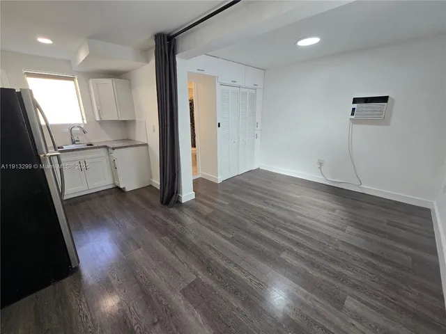 a kitchen with sink cabinets and wooden floor