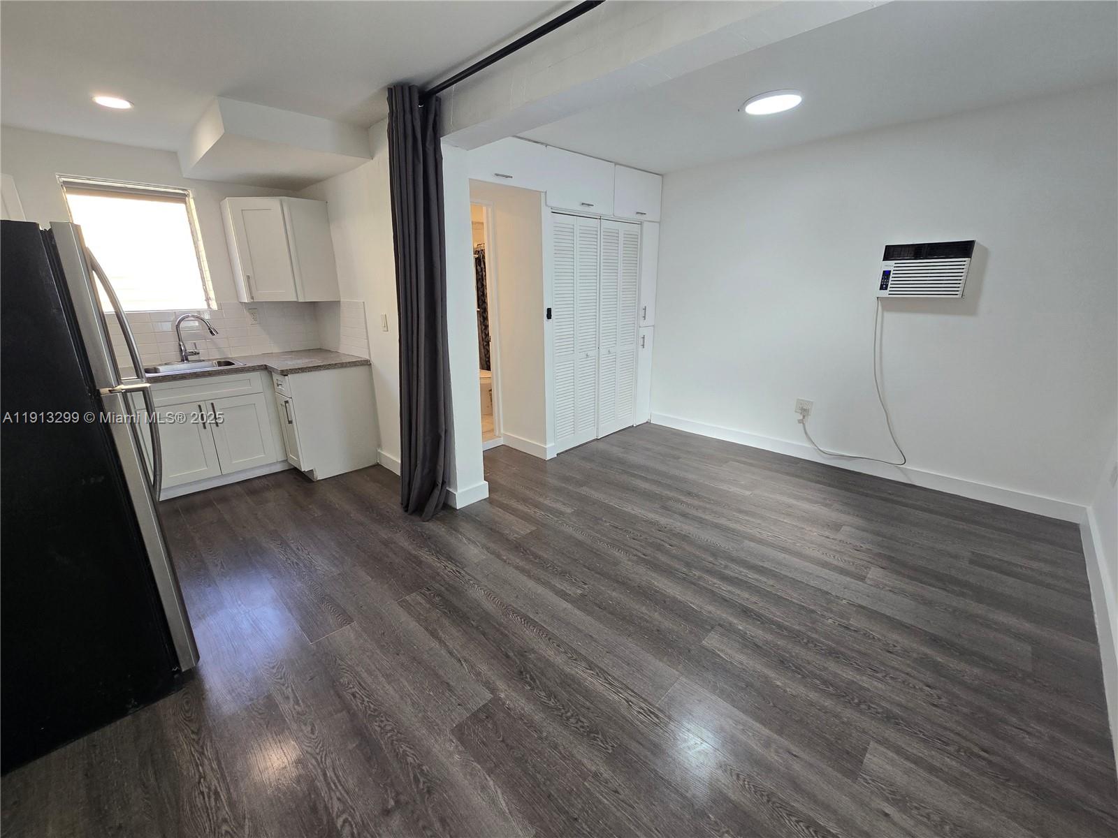 1629 Southwest 6th Street, Unit 13 Miami, FL 33135 - Photo 30 of 74 a view of a kitchen with wooden floor and electronic appliances