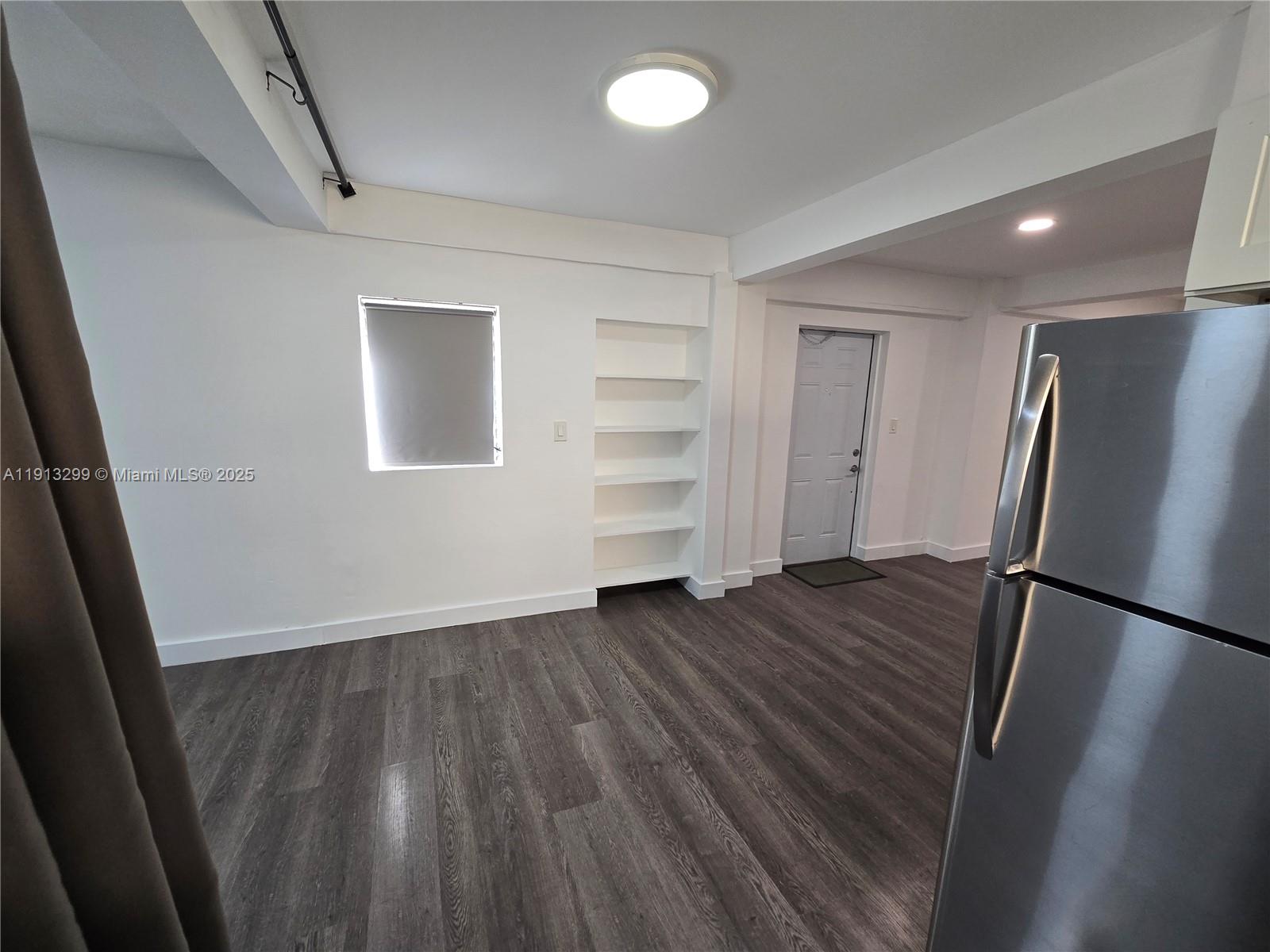 1629 Southwest 6th Street, Unit 13 Miami, FL 33135 - Photo 34 of 74 a view of empty room with wooden floor and window