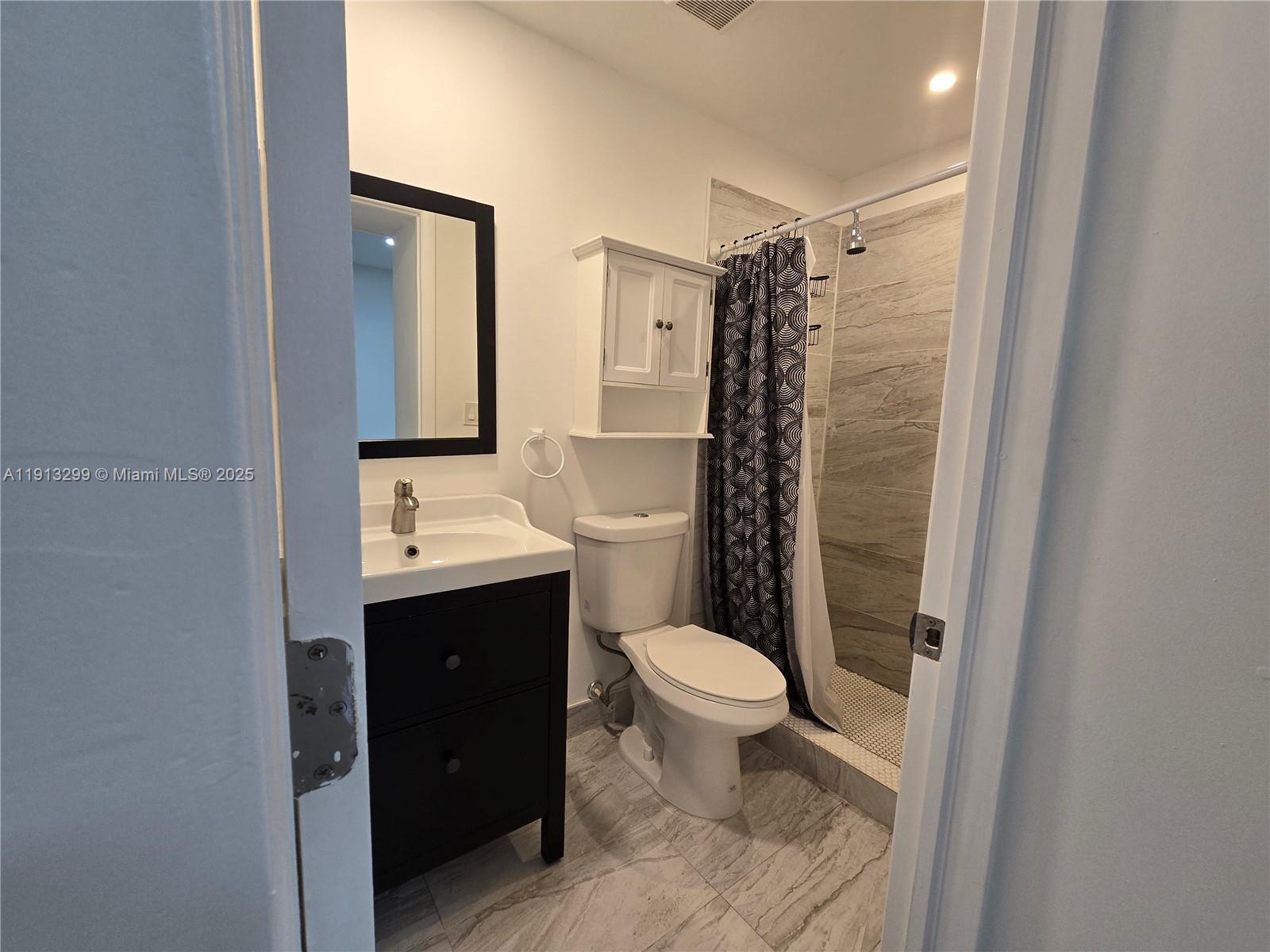 1629 Southwest 6th Street, Unit 13 Miami, FL 33135 - Photo 36 of 74 a bathroom with a toilet a sink and shower