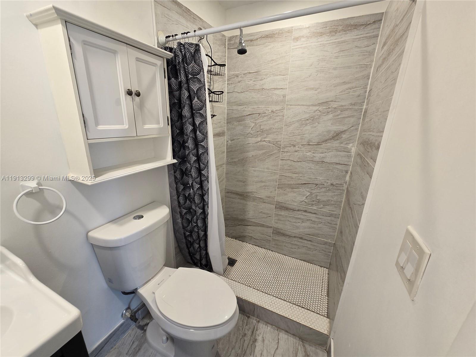 1629 Southwest 6th Street, Unit 13 Miami, FL 33135 - Photo 38 of 74 a white toilet sitting next to a shower