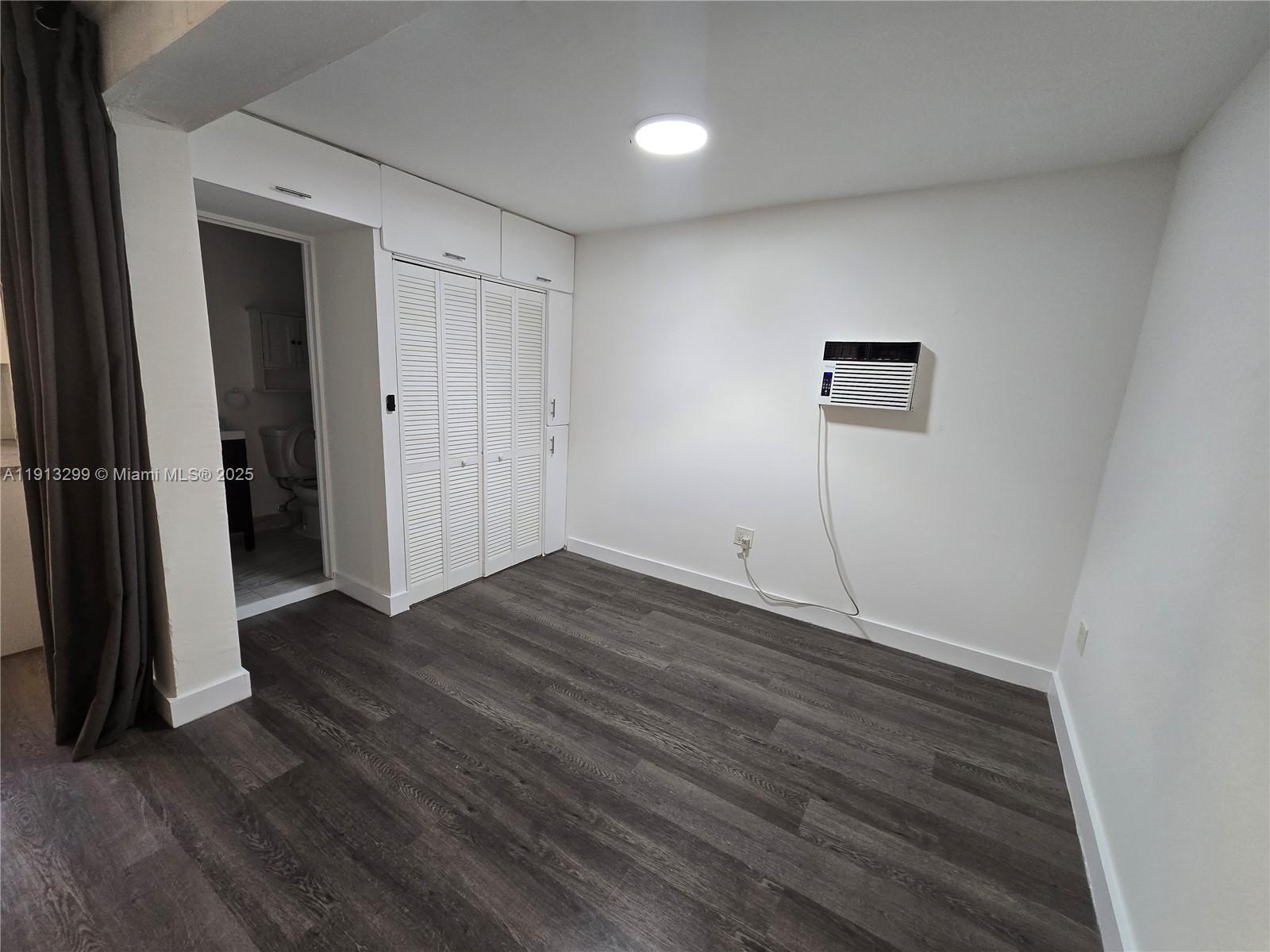 1629 Southwest 6th Street, Unit 13 Miami, FL 33135 - Photo 39 of 74 an empty room with wooden floor and closet