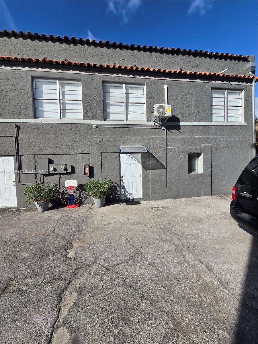 1629 Southwest 6th Street, Unit 13 Miami, FL 33135 - Photo 41 of 74 front view of a house with a yard and car parked
