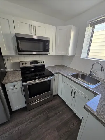 a view of a room with wooden floor and staircase