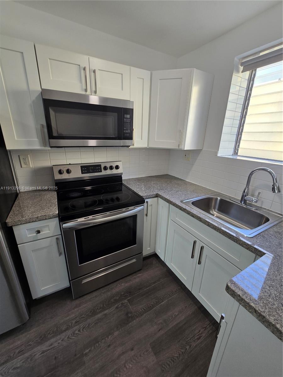 1629 Southwest 6th Street, Unit 13 Miami, FL 33135 - Photo 49 of 74 a kitchen with a stove and a microwave