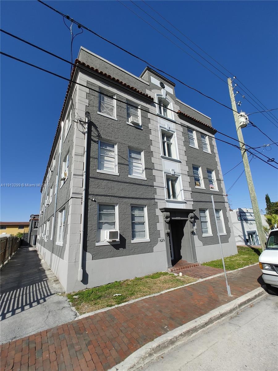1629 Southwest 6th Street, Unit 13 Miami, FL 33135 - Photo 5 of 74 a front view of a residential apartment building with a yard