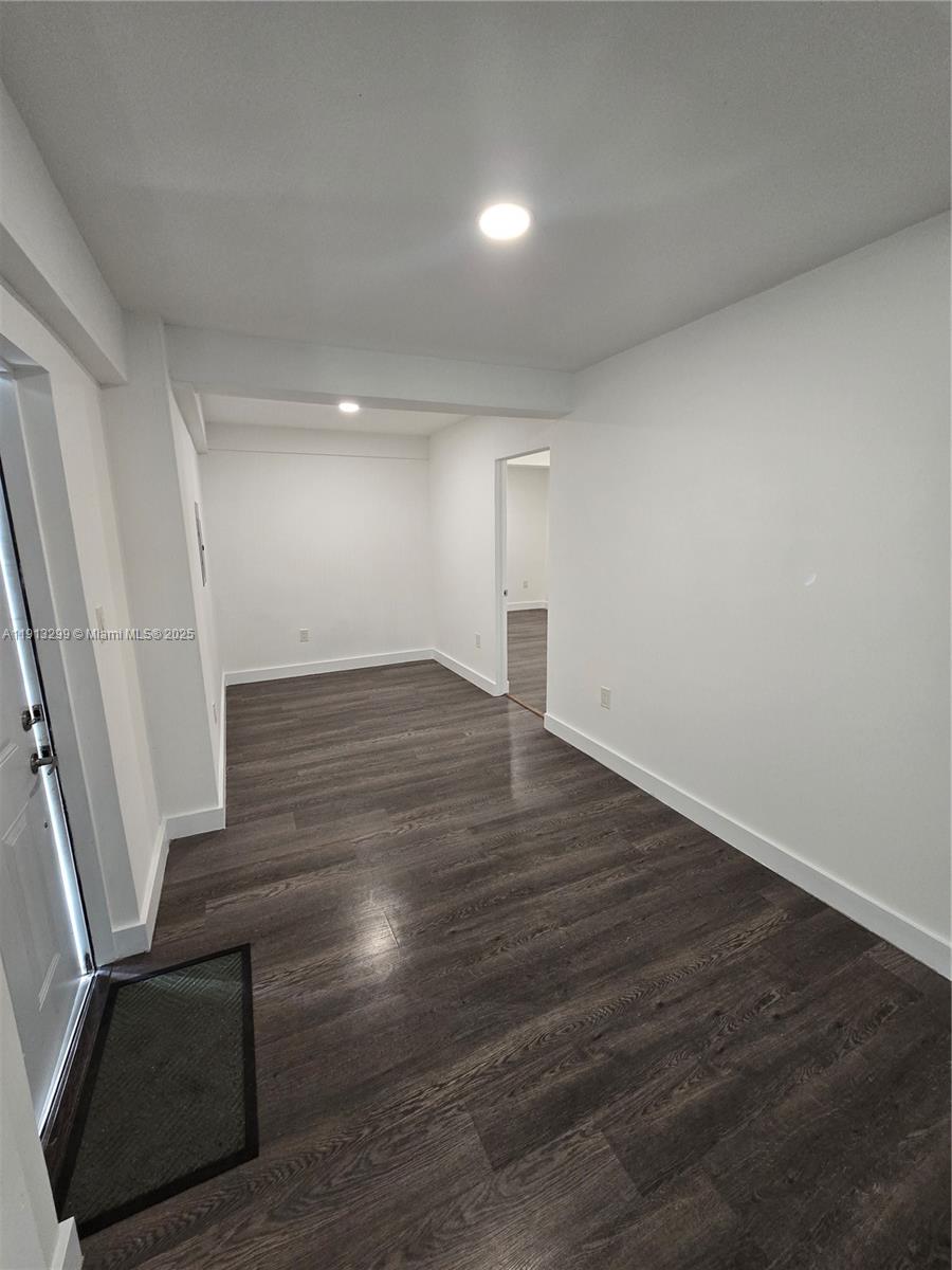 1629 Southwest 6th Street, Unit 13 Miami, FL 33135 - Photo 53 of 74 a view of an empty room with wooden floor and stairs