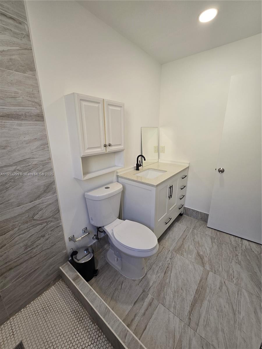 1629 Southwest 6th Street, Unit 13 Miami, FL 33135 - Photo 64 of 74 a bathroom with a toilet a sink and a shower