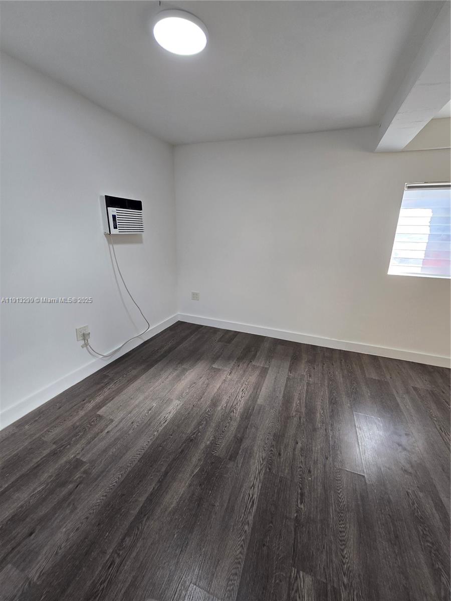 1629 Southwest 6th Street, Unit 13 Miami, FL 33135 - Photo 74 of 74 an empty room with wooden floor and windows