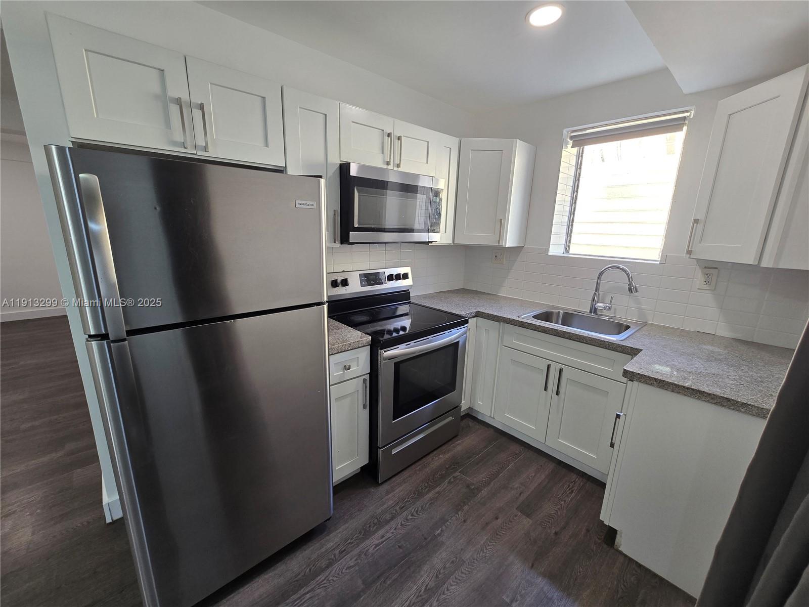 1629 Southwest 6th Street, Unit 13 Miami, FL 33135 - Photo 8 of 74 a kitchen with a refrigerator stove and sink