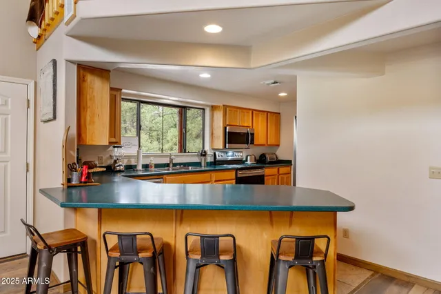 a living room with furniture a ceiling fan and a rug