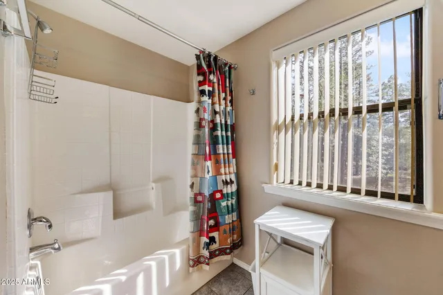 a bedroom with a bed wooden floor and window