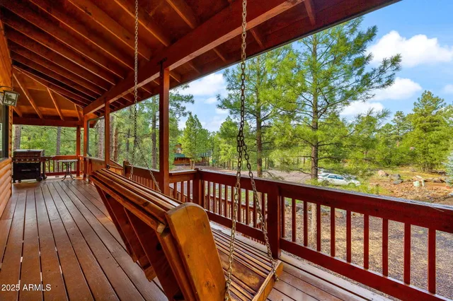 a view of a chairs and table in the yard next to a yard